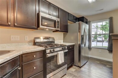 Bright and cheery kitchen! Brushed nickel fixtures.