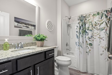 Full bath featuring vanity, wood finished floors, 
