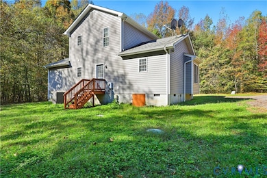 Rear view of house featuring a lawn, crawl space, and roof with shingles