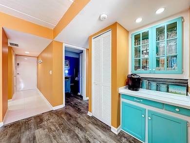 Hall featuring recessed lighting and dark wood-style floors
