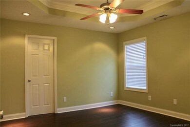 Relax in this master bedroom which has hardwood fl