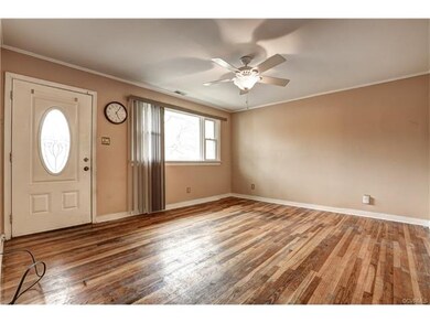 living room features Neutral color paint, charming wood floors and ceiling fan