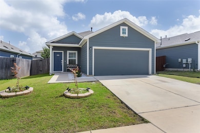 Single story home featuring a garage and concrete