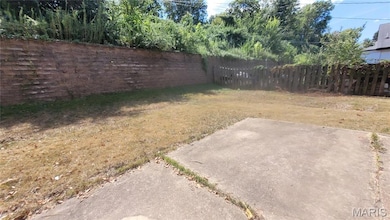 Fenced backyard with a patio area