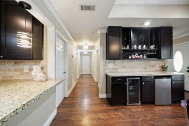 The spacious laundry room, bedrooms and secondary bath are off this hall