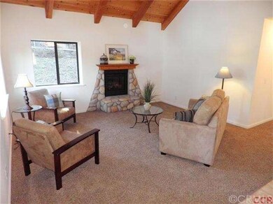 Lovely living room with stone hearth gas fireplace