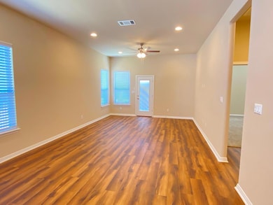 Spare room featuring wood finished floors, recess