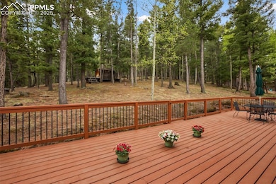 Wooden terrace with outdoor dining area and view of scattered trees
