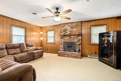 Den/living area with brick fireplace.  Wood burning stove conveys.