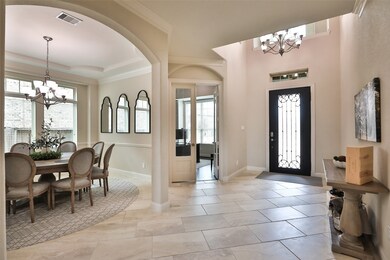 Beautiful tile floors, high ceiling, crown molding. Through the french doors is the private study.