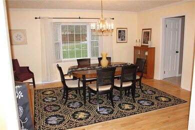 Dining room with maple hardwood flooring, crown mo