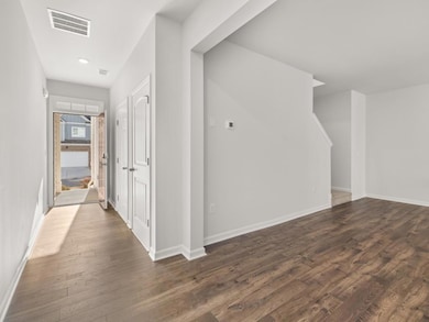 Hall featuring dark wood-style floors