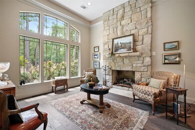 Formal living room at the front of the home has brand new hardwood flooring, stone fireplace and high ceilings.