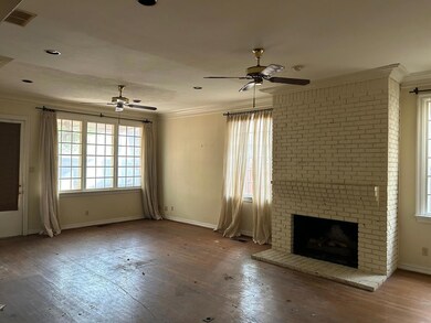 Unfurnished living room featuring crown molding, a