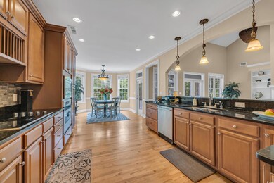 Kitchen with appliances with stainless steel finishes, a sink, decorative light fixtures, brown cabinetry, and recessed lighting