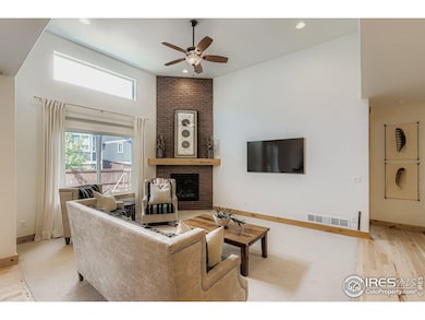 Floor to ceiling brick fireplace anchors this bright living space.