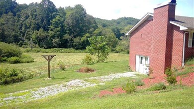 Field behind the home with a small stream goes wit