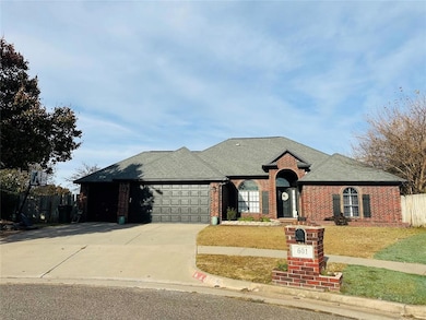 View of front of home featuring a garage and a front lawn