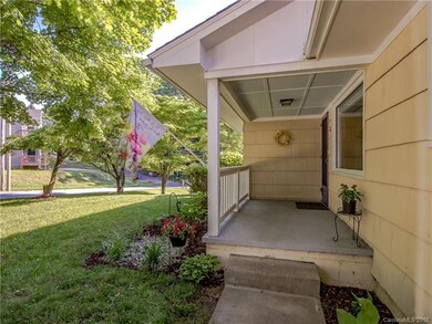 Relax on your covered front porch so close to Haywood Rd.
