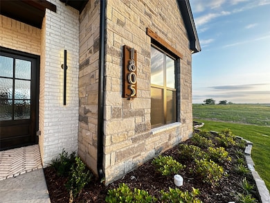 View of side of home with brick siding and stone siding
