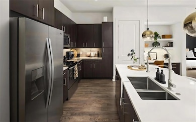 Kitchen featuring tasteful backsplash, dark brown 