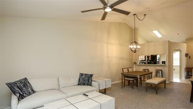 Carpeted living room with ceiling fan with notable