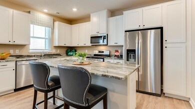 Stainless steel appliances and granite countertops. Image is of model, colors may vary.