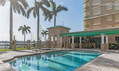 Community pool with fence, a hot tub, and a patio