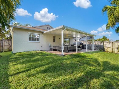 Rear view of house featuring a fenced backyard, a patio, stucco siding, an outdoor hangout area, and a ceiling fan