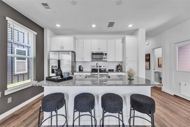 Kitchen with visible vents, stainless steel appliances, and a breakfast bar area