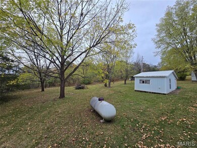View of green lawn with an outbuilding