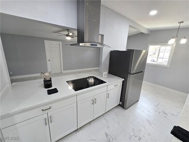 Kitchen with marble finish floor, freestanding ref