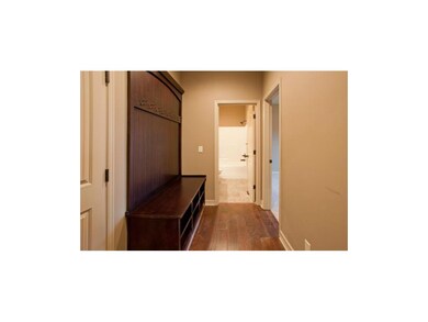 Built-in custom bench with coat hooks at garage en