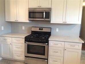 Kitchen with stainless steel appliances and white cabinets