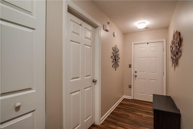 Entry with neutral paint, updated floor and coat c