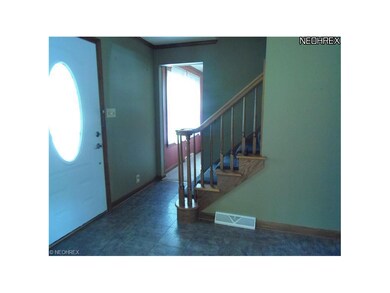 Foyer. Vinyl tile floor. Entry to formal dinig roo