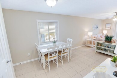 Tiled dining space featuring ceiling fan