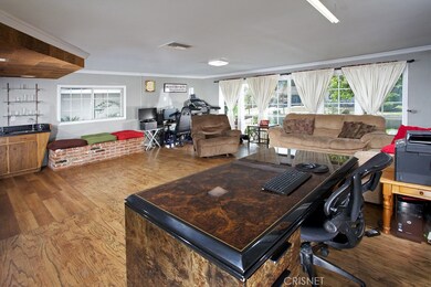 The expansive family/bonus room with crown molding, raised brick window seat, full wet-bar, sliding doors leading to the front yard, washer/dryer hook-up in closet, wood flooring and private entry is perfect for entertaining, a media room, or private