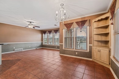 Unfurnished living room with crown molding, ceilin