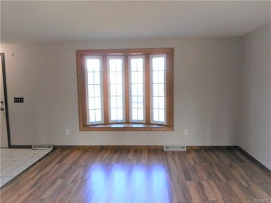 This view shows the ceramic foyer and front door. 