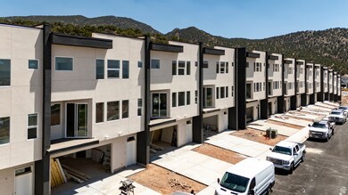 View of property featuring a mountain view and concrete driveway
