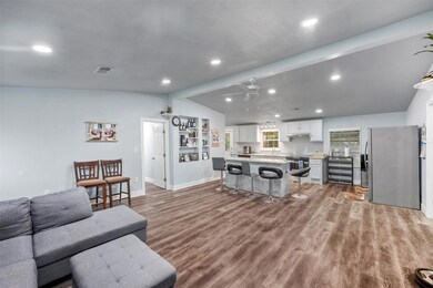 Living room featuring ceiling fan, light hardwood 