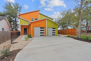 View of front facade featuring fence and concrete