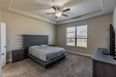 Come and unwind after a long day in this magnificent master suite! This spacious room features plush carpet, custom paint, tray ceilings, dark stained ceiling fan with lighting, and large windows with privacy blinds.