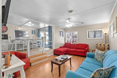 Living area featuring wood finished floors and ceiling fan