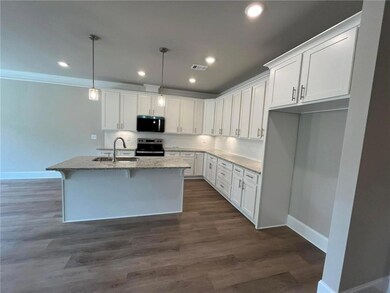 Kitchen with a center island with sink, visible ve