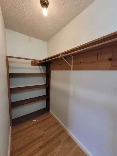 Walk in closet featuring light wood-style floors