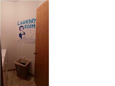 Laundry room has cabinets and hanging bar and on t