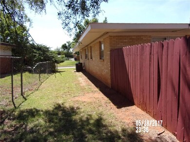 SIDE VIEW OF HOUSE AND FENCES