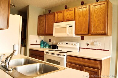 Kitchen view with laundry room and storage on the